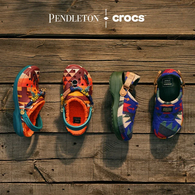 Crocs on wooden environment.