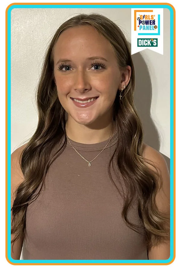 girl smiling in brown shirt