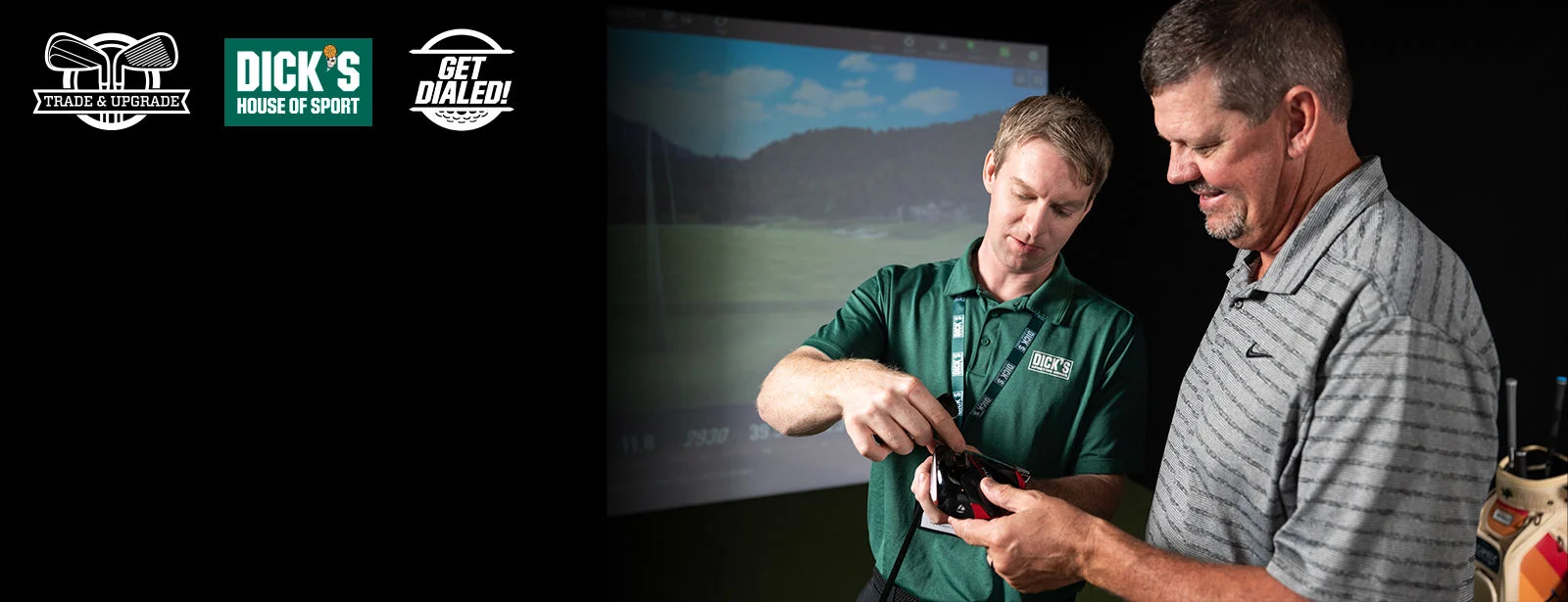 Athlete and store teammate in store in front of golf simulator. 