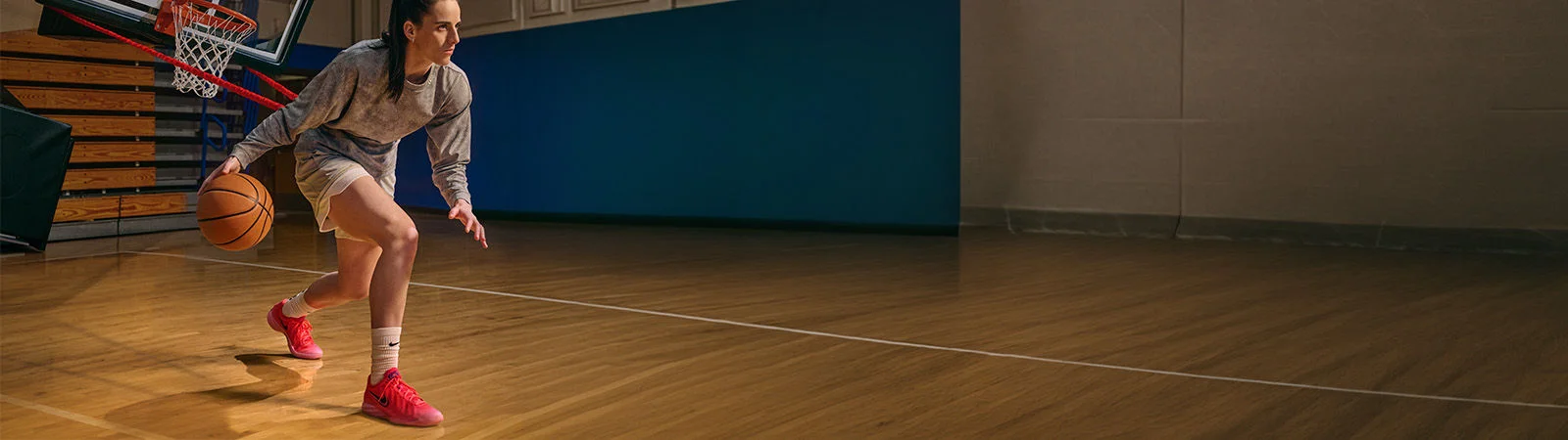 Caitlin Clark dribbling basketball.