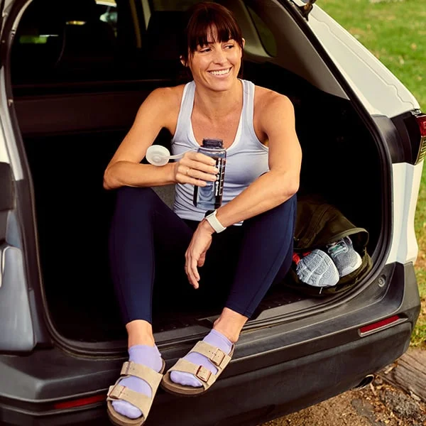 Close up of a woman wearing recovery shoes and apparel.