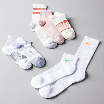 Collection of socks on grey background.