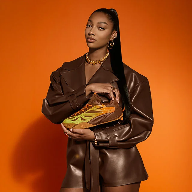 Angel Reese holding basketball shoes