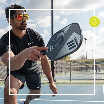 Pickleball player hitting pickleball.