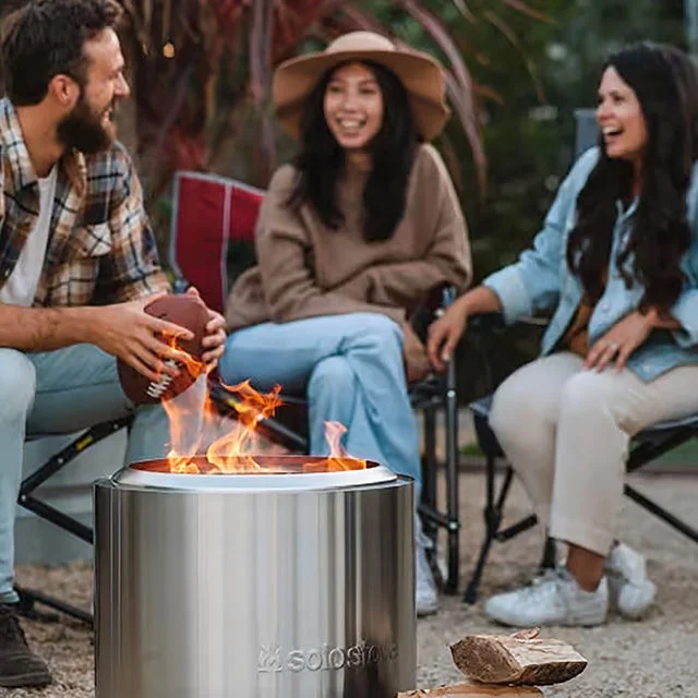 People relaxing around a solo stove.