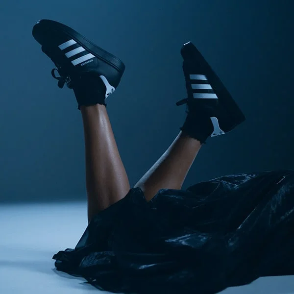 Person wearing adidas shoes. 