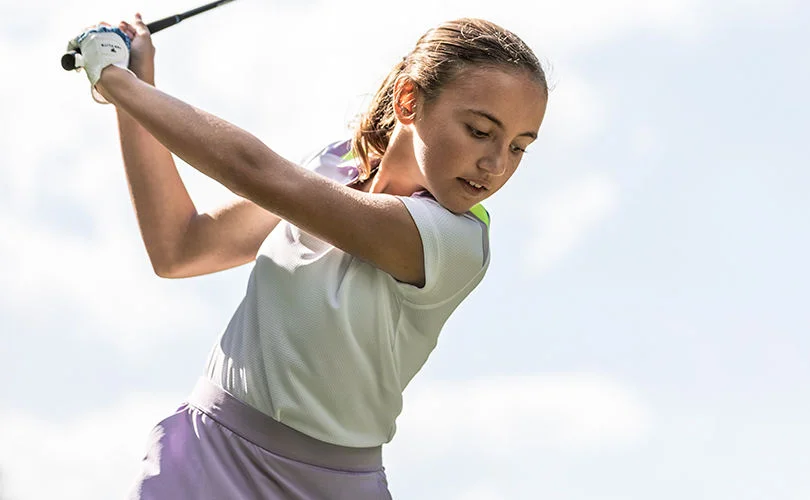 A girl golfing.