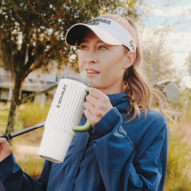 Nelly Korda holding Stanley 1913 tumbler.