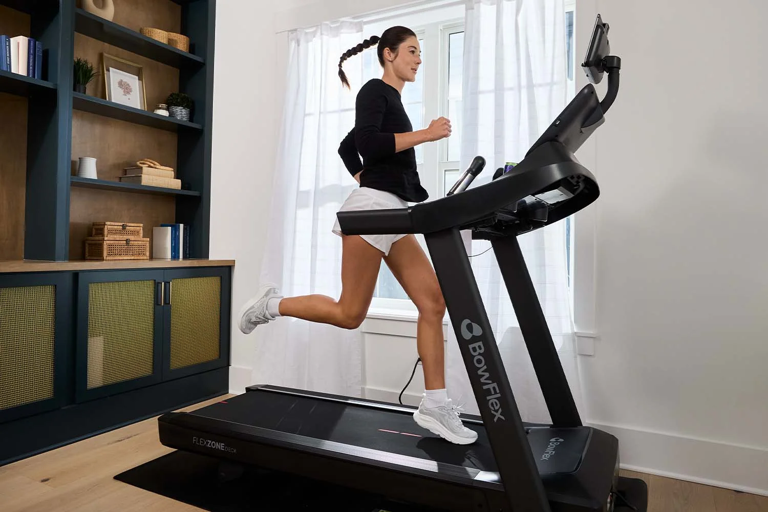 person running on treadmill in home gym