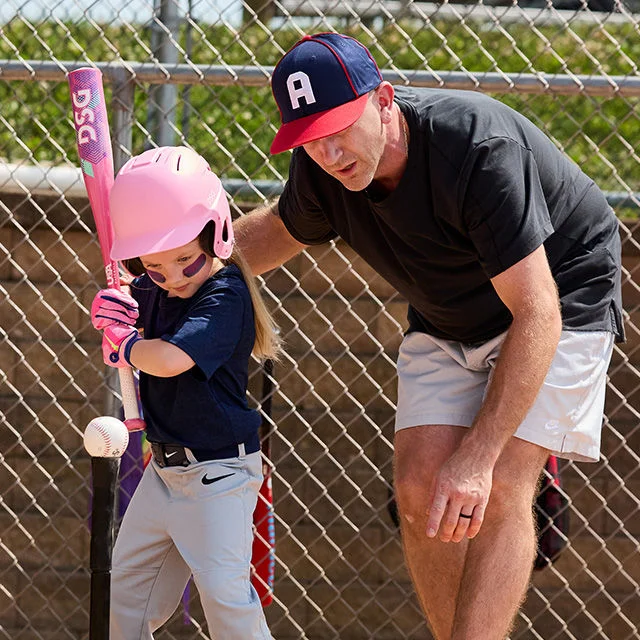 Young softball player and coach.