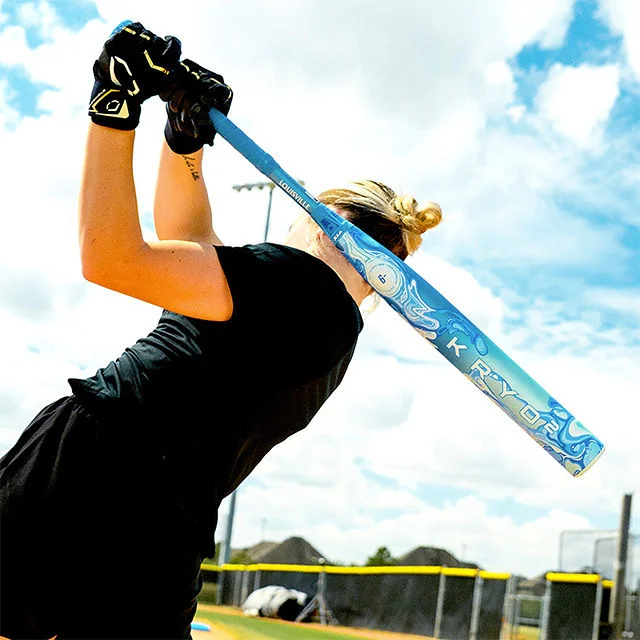 Softball player taking a swing.