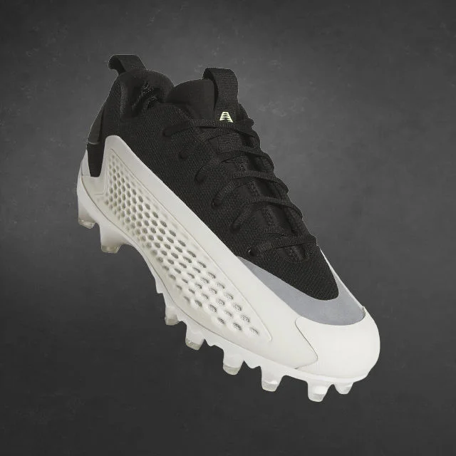 adidas football cleat in dark environment.