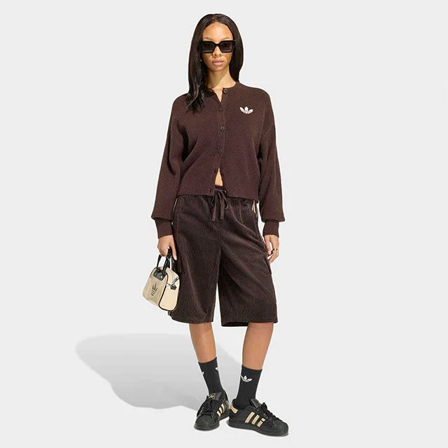 Woman in adidas cardigan.