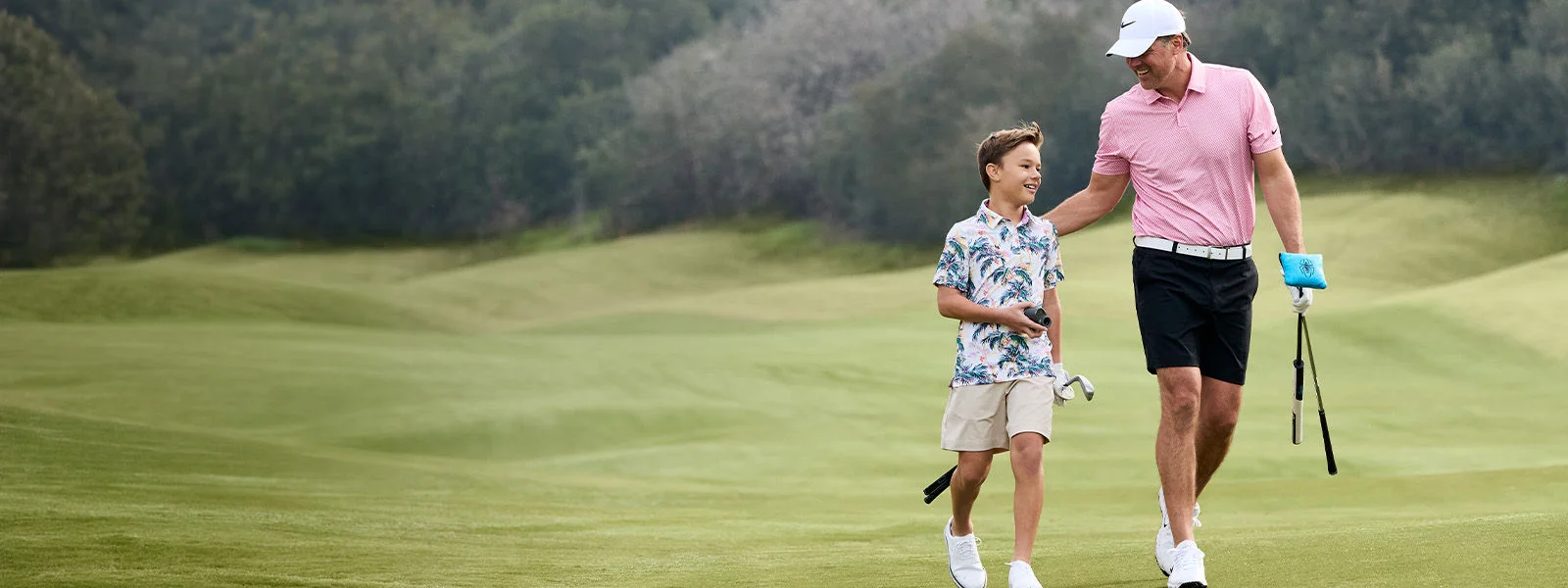Father and son on golf course. 