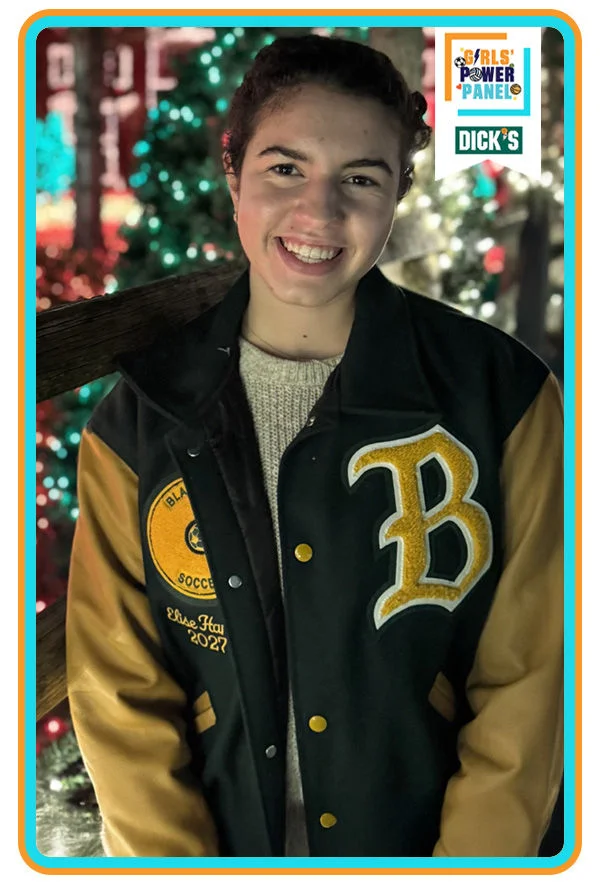 girl smiling in varsity jacket