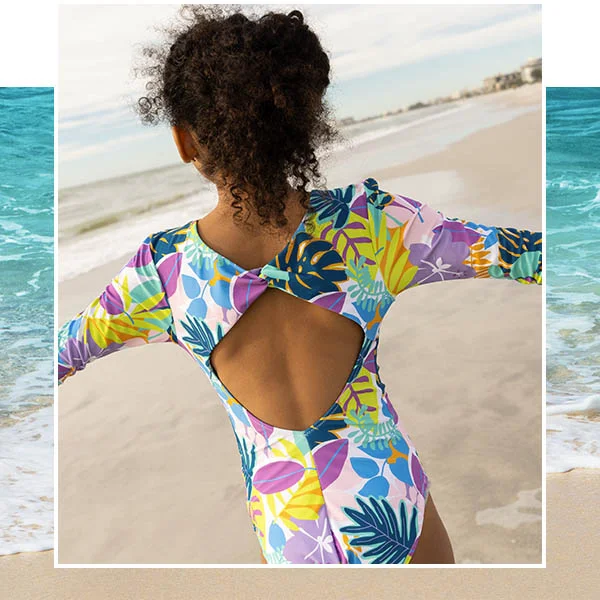 A young girl in swimwear at the beach.