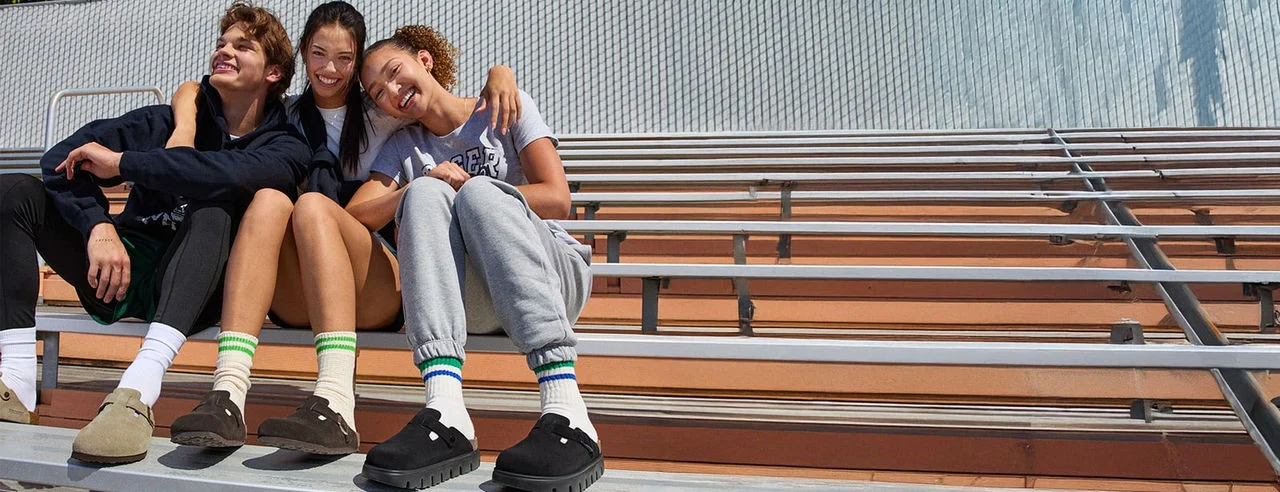 High school kids sitting on bleachers. 