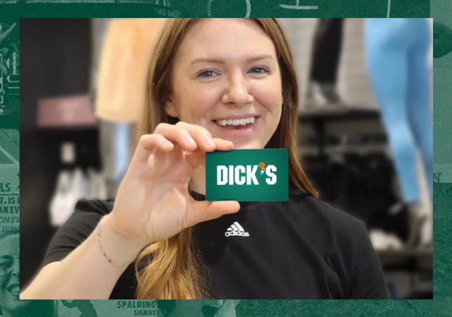 Teammate holding a DICK'S giftcard. 
