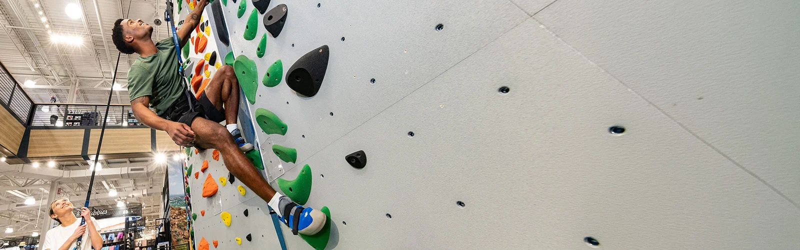 A man climbing an indoor rock wall