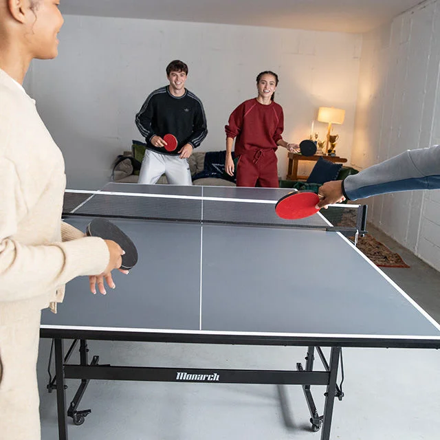 Teens playing table tennis.