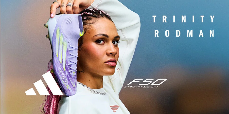 Trinity Rodman holding a soccer cleat.
