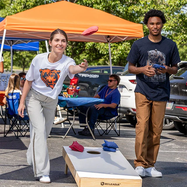 Two people playing bags.