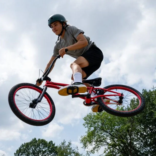Athlete jumping with bike.