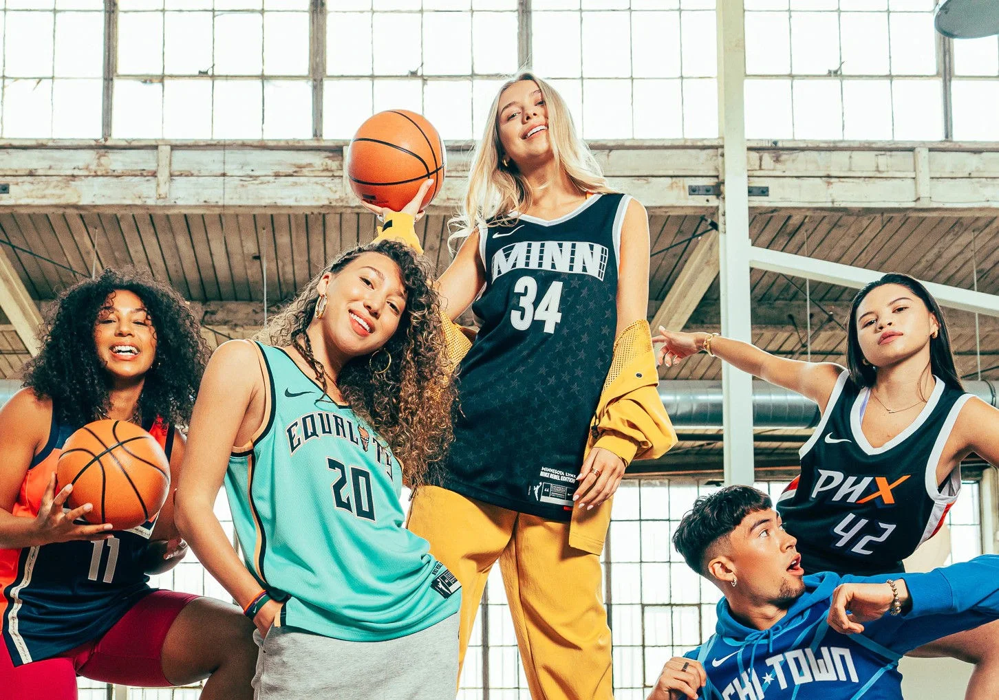 Women wearing WNBA jerseys.
