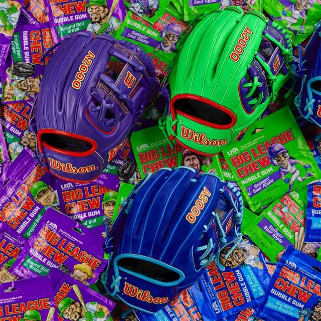Three Wilson A2000 gloves sitting on Big Chew bubble gum packets.