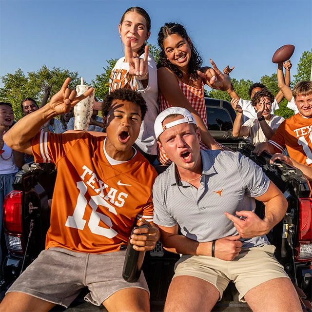 College fans cheering outdoors.