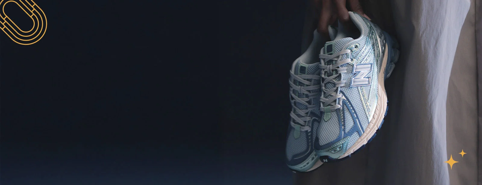 Athlete holding shoes.