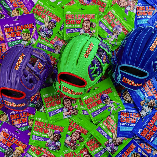 Baseball gloves on top of big league chew packets.