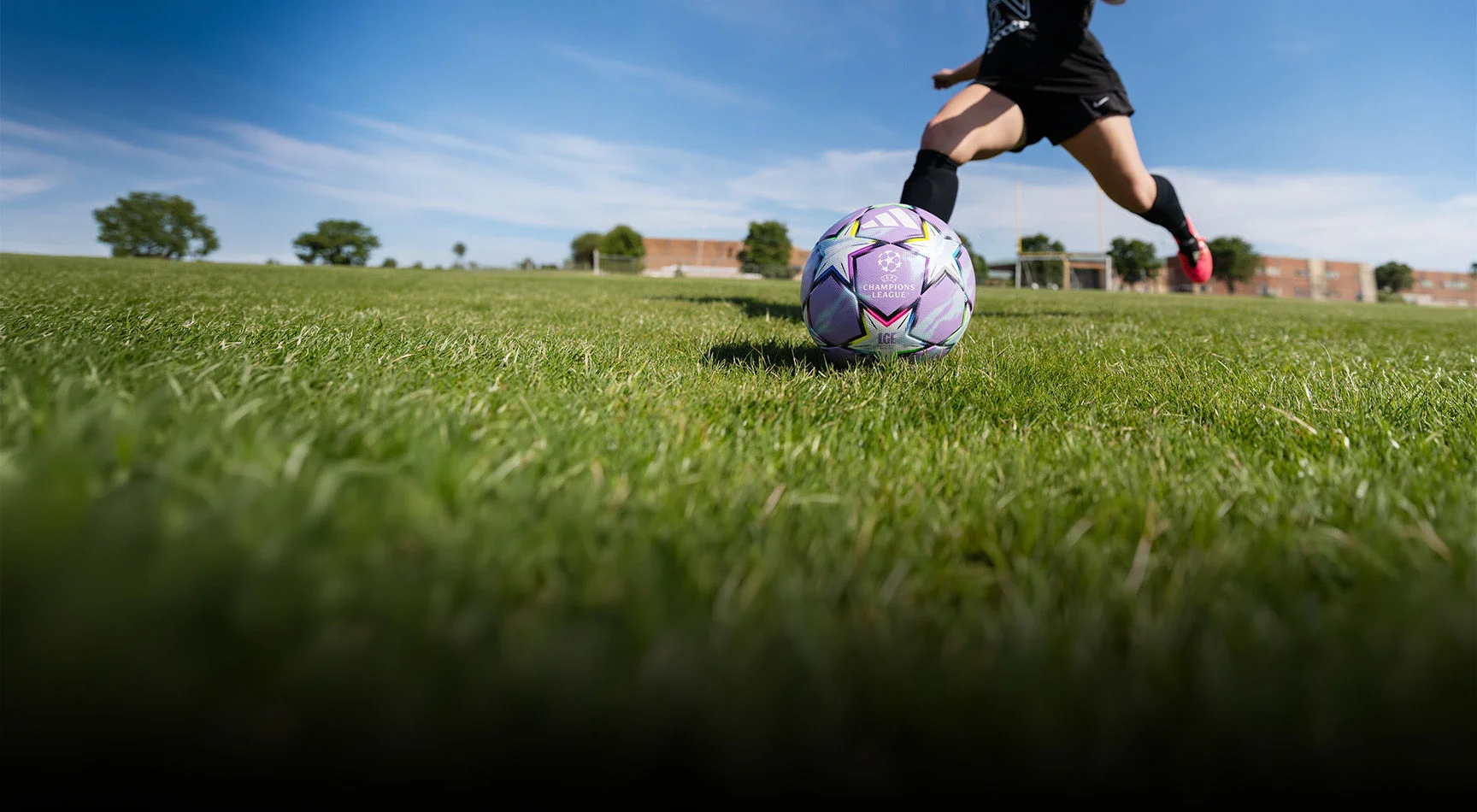 Athlete kicking soccer ball