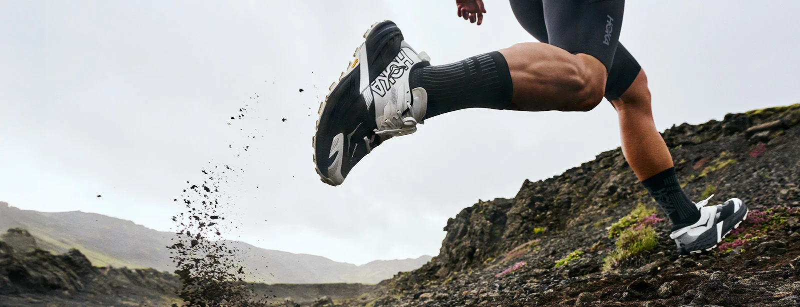 Person running outside on rocky terrain. 