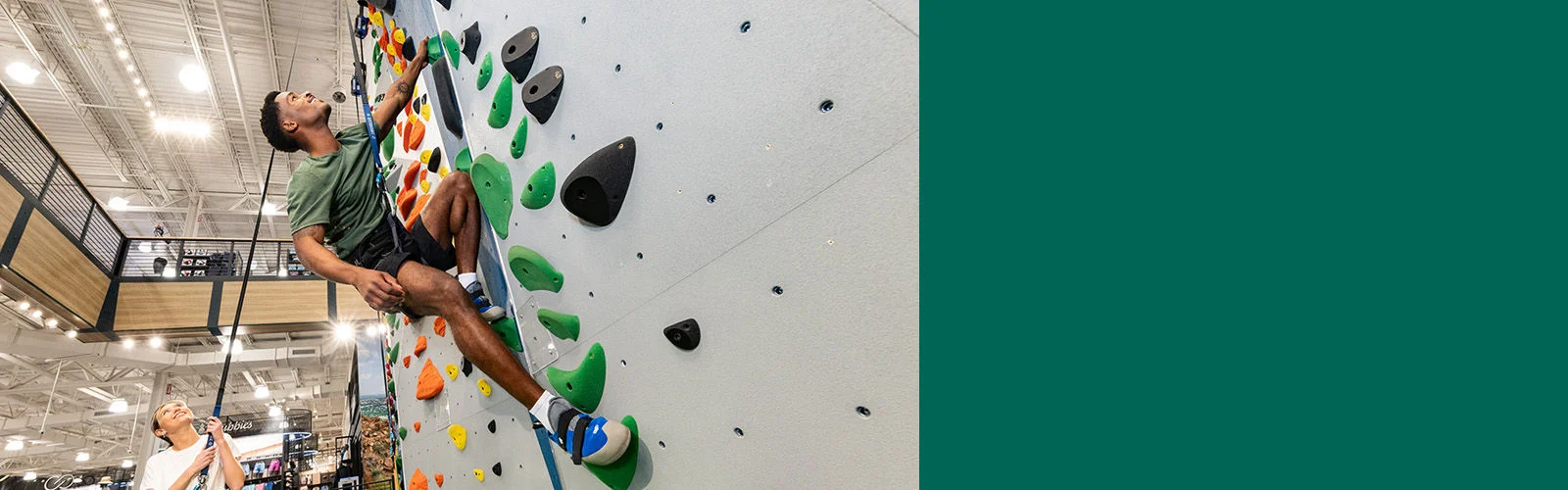 A man climbing an indoor rock wall