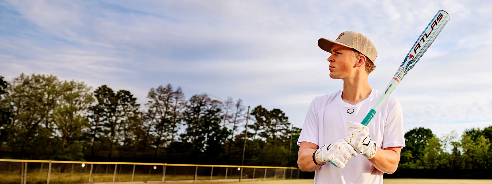 Baseball player holding bat.