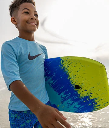 A young boy wearing rash guard apparel.