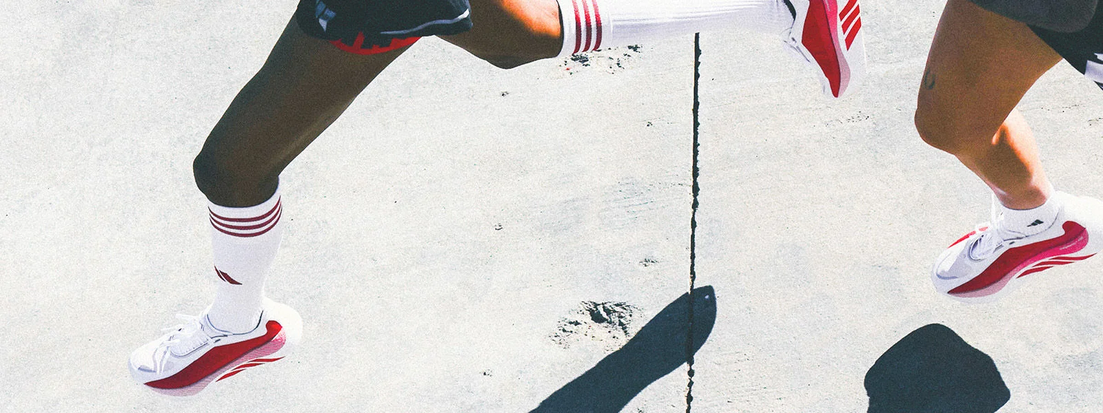 Athletes running outside and running footwear.