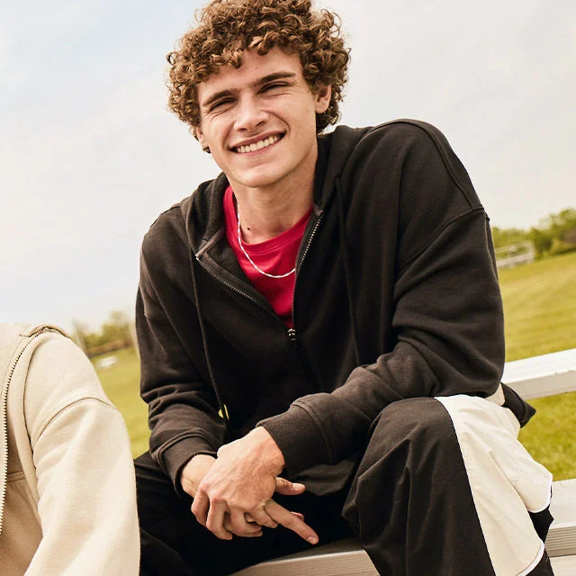 Man in hoodie with a group of friends. 