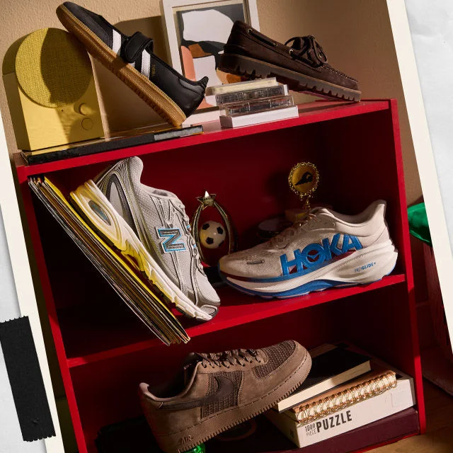 Shoes stacked on a shelf in a dorm room.