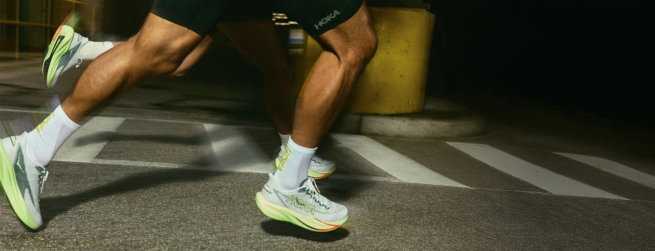 People running in HOKA shoes. 