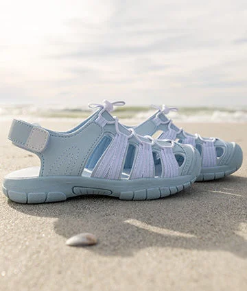 A pair of sandals on the beach.