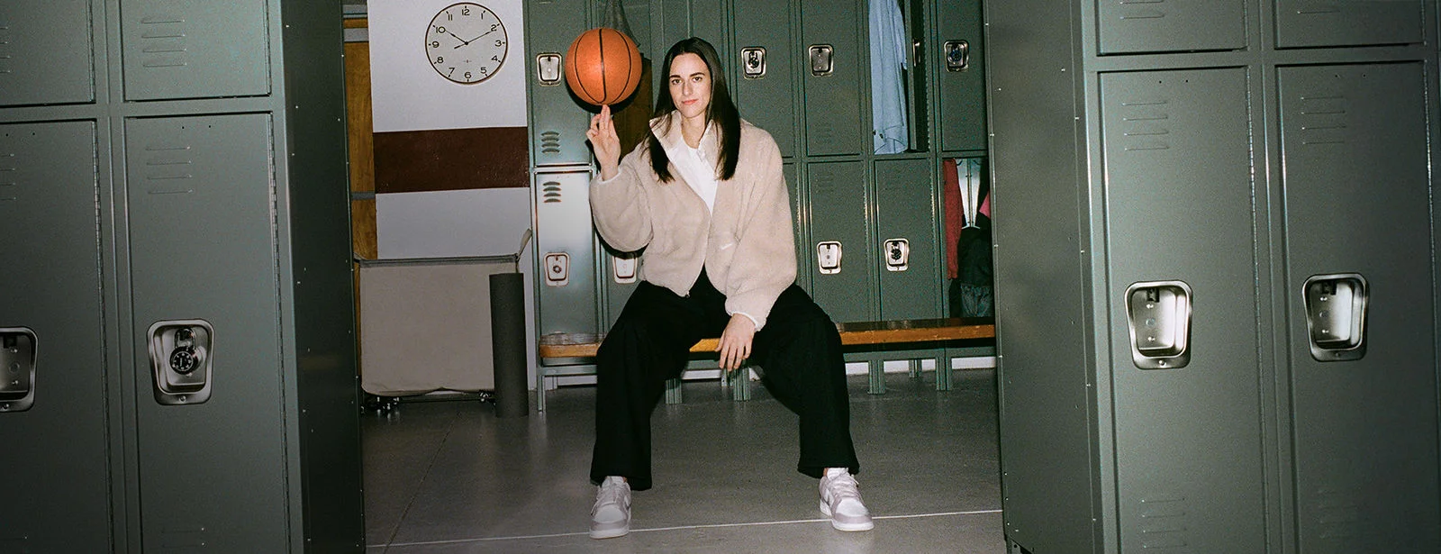 Caitlin Clark in a basketball locker room. 