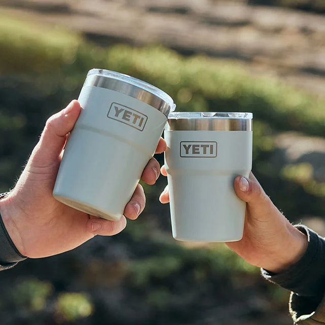 Two people holding YETI Ridgeline bottles