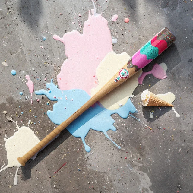 Ice cream themed baseball bat on pavement next to spilled ice crea.
