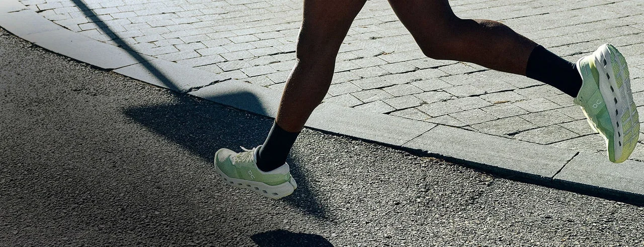 Woman running outside on a bridge. 