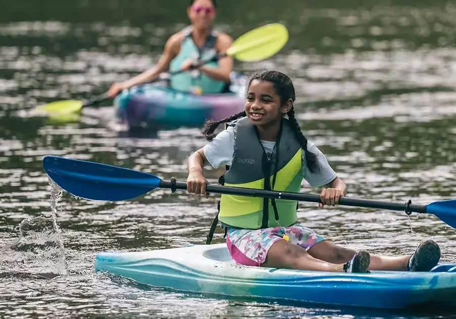 Young athletes kayaking on the water.