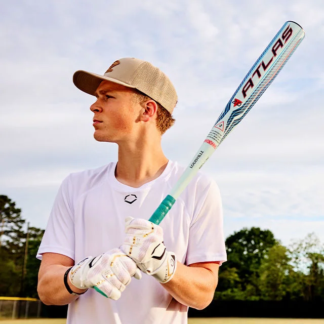Baseball player holding bat.