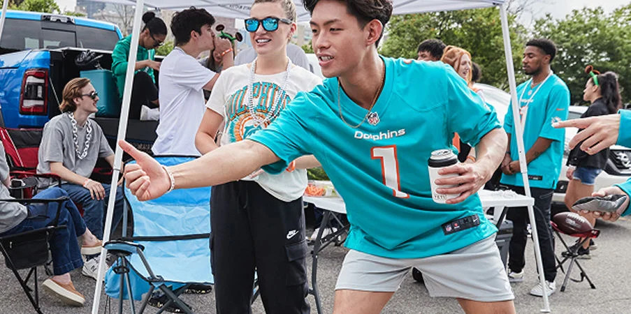 man throwing cornhole in jersey