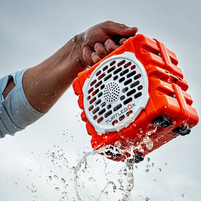 Athlete holding turtlebox.